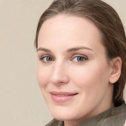 Joyful white young-adult female with medium  brown hair and blue eyes