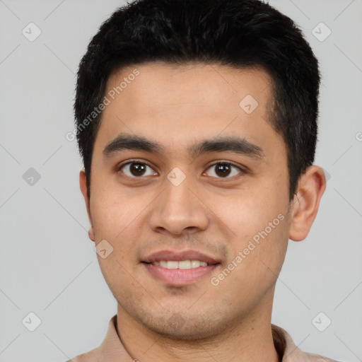 Joyful latino young-adult male with short  black hair and brown eyes