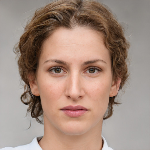 Joyful white young-adult female with medium  brown hair and green eyes