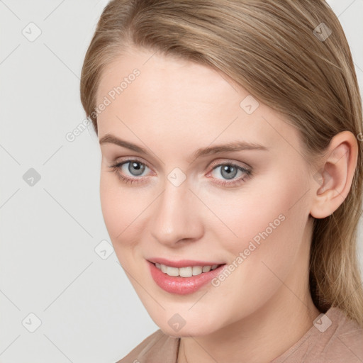 Joyful white young-adult female with long  brown hair and grey eyes