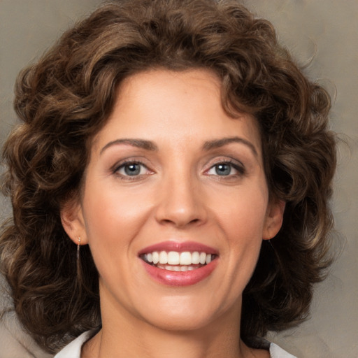 Joyful white young-adult female with medium  brown hair and green eyes