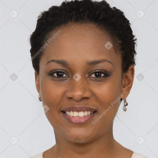 Joyful black young-adult female with short  black hair and brown eyes