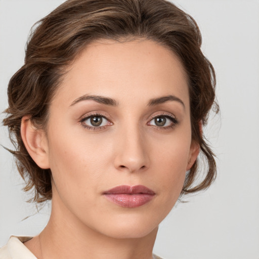 Joyful white young-adult female with medium  brown hair and green eyes