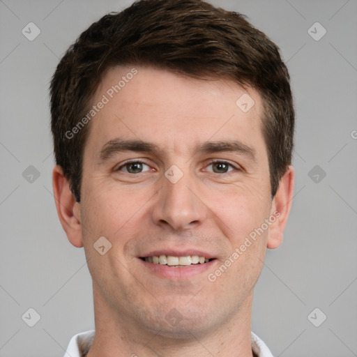 Joyful white young-adult male with short  brown hair and grey eyes