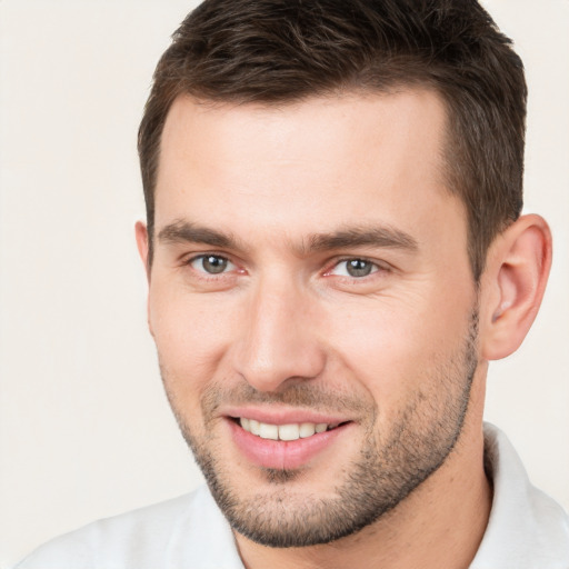 Joyful white young-adult male with short  brown hair and brown eyes