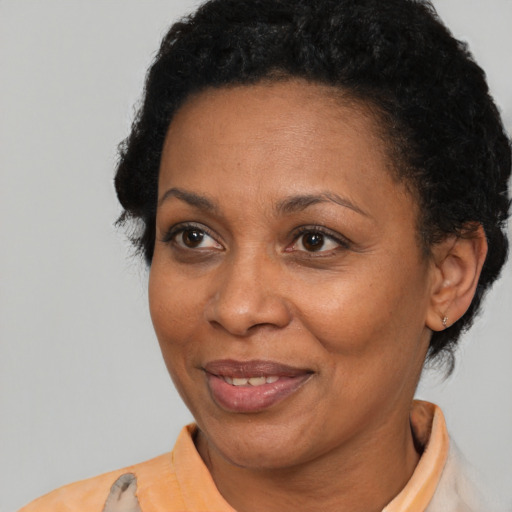 Joyful black adult female with short  brown hair and brown eyes