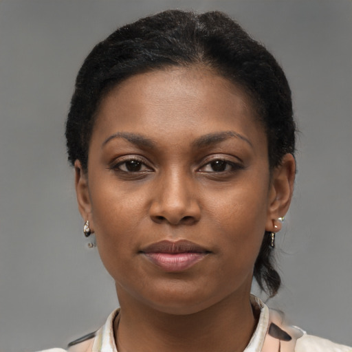Joyful black young-adult female with short  brown hair and brown eyes