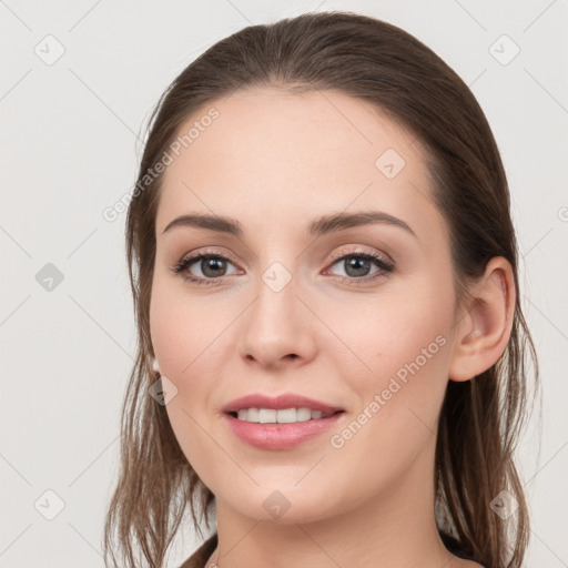 Joyful white young-adult female with long  brown hair and grey eyes