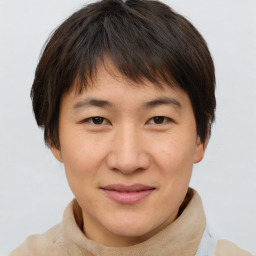 Joyful asian young-adult female with short  brown hair and brown eyes