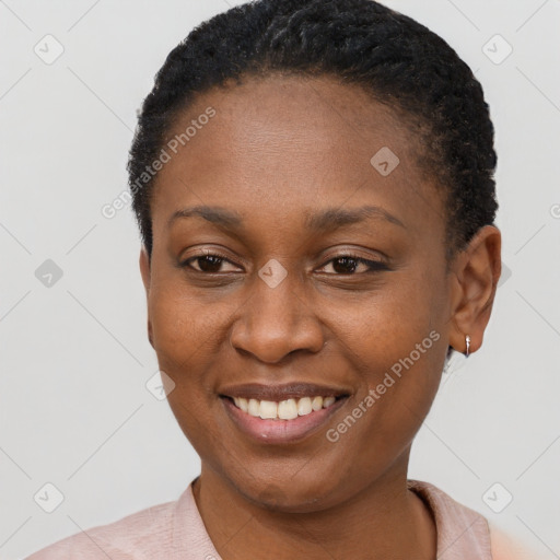 Joyful black young-adult female with short  brown hair and brown eyes