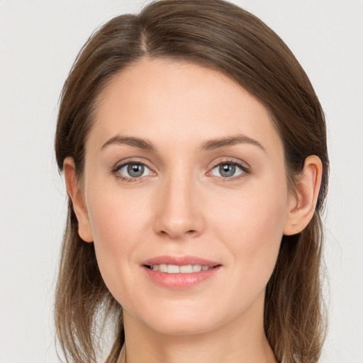 Joyful white young-adult female with long  brown hair and grey eyes