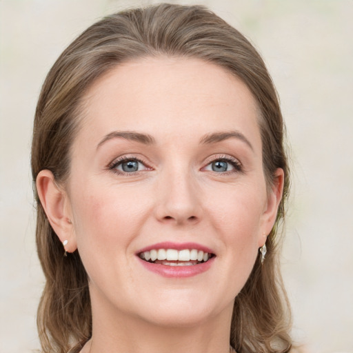 Joyful white young-adult female with medium  brown hair and blue eyes