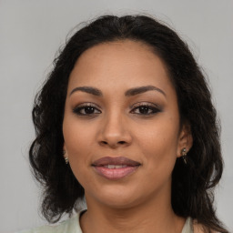 Joyful latino young-adult female with medium  brown hair and brown eyes