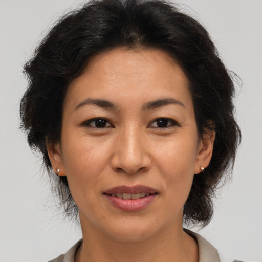 Joyful asian adult female with medium  brown hair and brown eyes