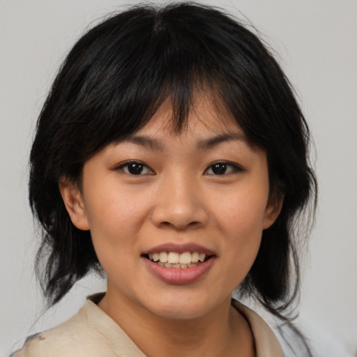 Joyful asian young-adult female with medium  brown hair and brown eyes