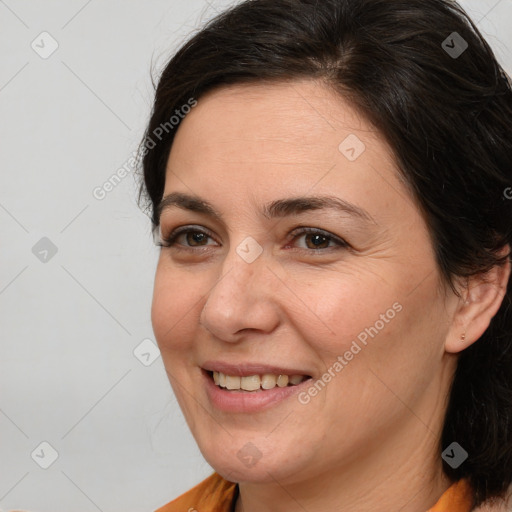 Joyful white adult female with medium  brown hair and brown eyes