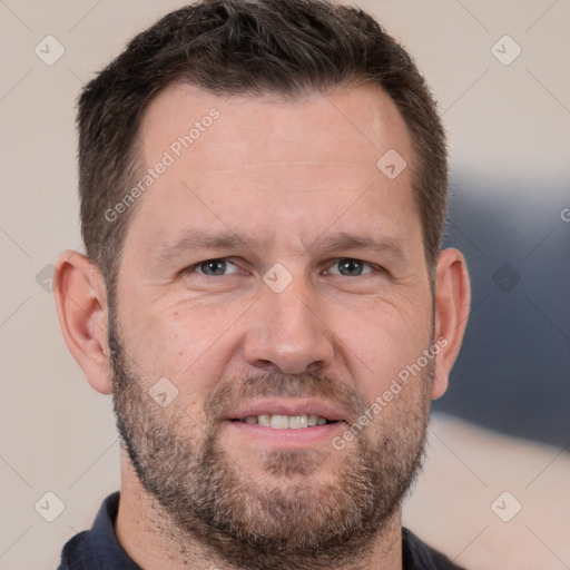 Joyful white adult male with short  brown hair and brown eyes