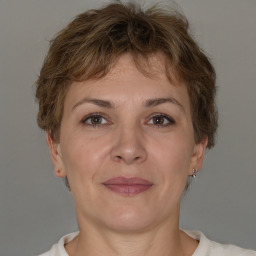 Joyful white adult female with short  brown hair and brown eyes