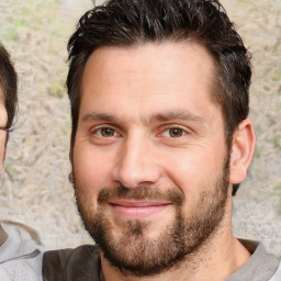 Joyful white adult male with short  brown hair and brown eyes