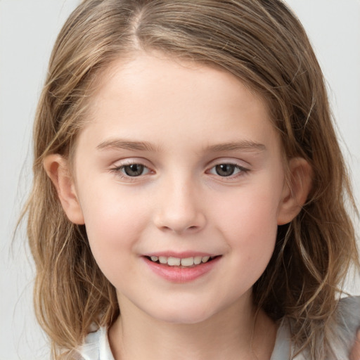 Joyful white child female with medium  brown hair and grey eyes