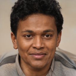 Joyful latino young-adult male with short  brown hair and brown eyes