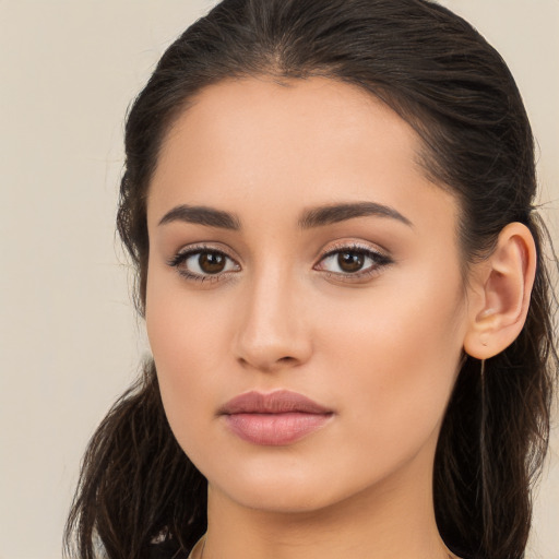 Joyful white young-adult female with long  brown hair and brown eyes