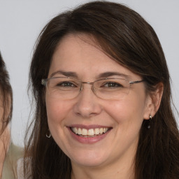 Joyful white adult female with long  brown hair and brown eyes