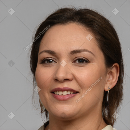 Joyful white adult female with medium  brown hair and brown eyes