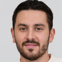 Joyful white young-adult male with short  brown hair and brown eyes