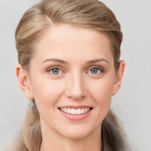 Joyful white young-adult female with long  brown hair and blue eyes