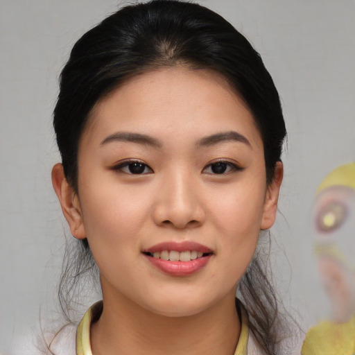 Joyful asian young-adult female with medium  brown hair and brown eyes