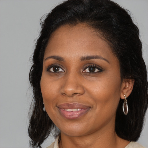 Joyful black young-adult female with medium  brown hair and brown eyes