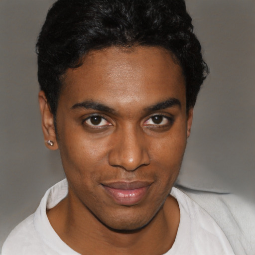 Joyful black young-adult male with short  brown hair and brown eyes