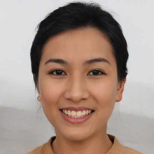 Joyful asian young-adult female with short  black hair and brown eyes