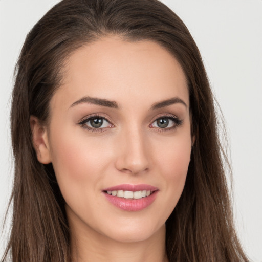 Joyful white young-adult female with long  brown hair and grey eyes