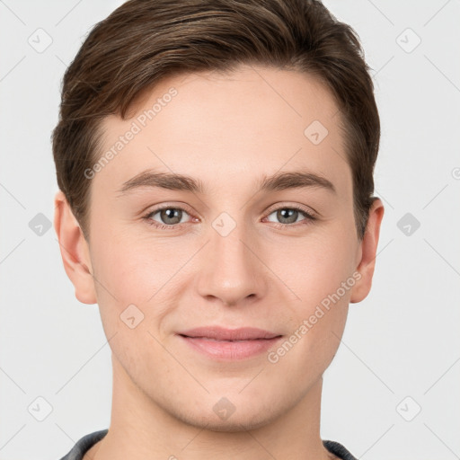 Joyful white young-adult male with short  brown hair and grey eyes