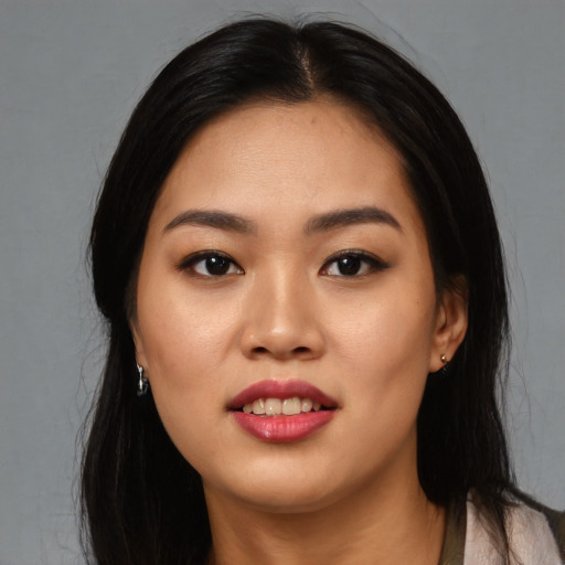 Joyful asian young-adult female with long  black hair and brown eyes