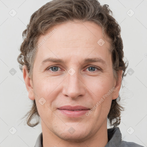 Joyful white adult female with short  brown hair and grey eyes