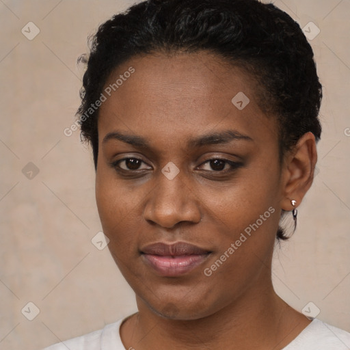 Joyful black young-adult female with short  black hair and brown eyes