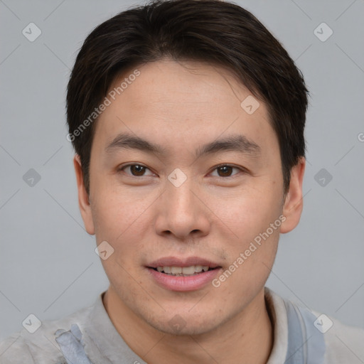 Joyful asian young-adult male with short  brown hair and brown eyes