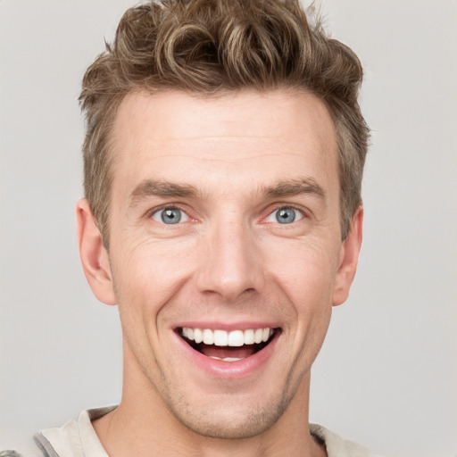 Joyful white adult male with short  brown hair and grey eyes