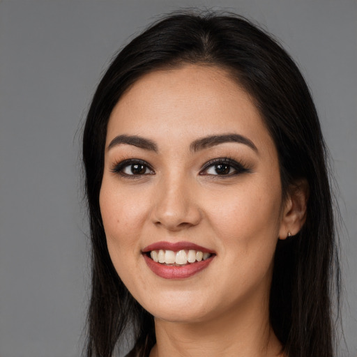 Joyful white young-adult female with long  black hair and brown eyes