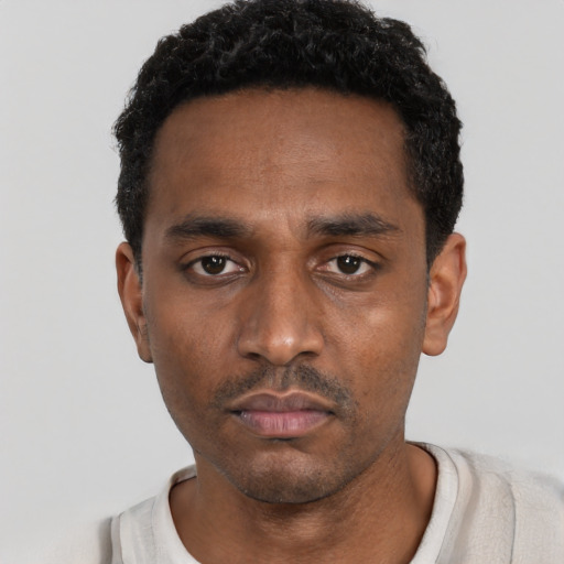 Neutral black young-adult male with short  black hair and brown eyes