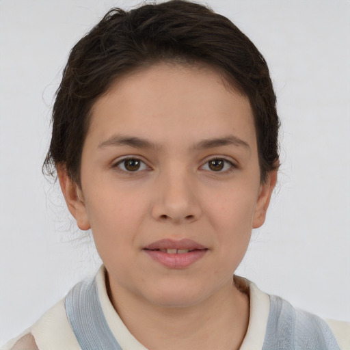 Joyful white child female with short  brown hair and brown eyes