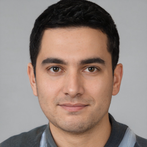 Joyful white young-adult male with short  black hair and brown eyes
