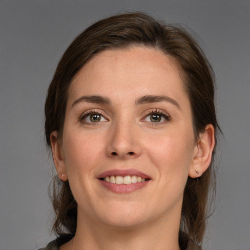 Joyful white young-adult female with medium  brown hair and brown eyes