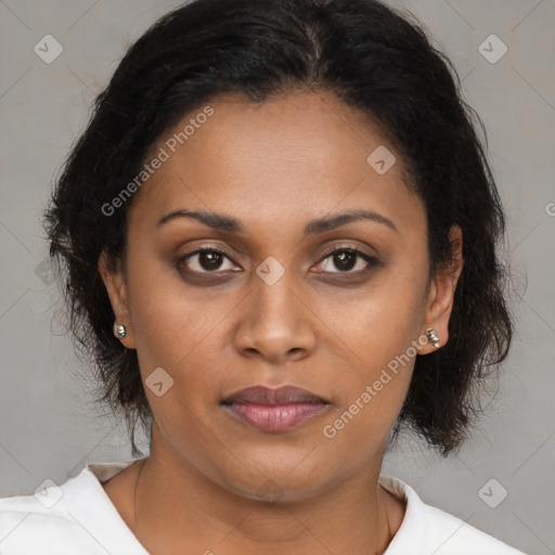 Joyful latino adult female with medium  brown hair and brown eyes