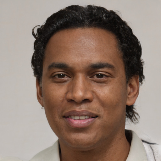 Joyful black young-adult male with short  black hair and brown eyes