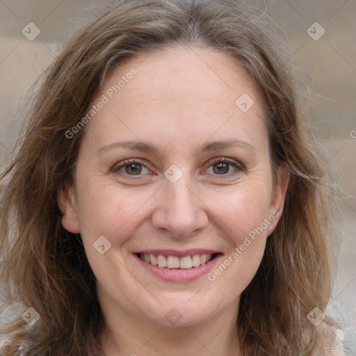 Joyful white adult female with long  brown hair and grey eyes