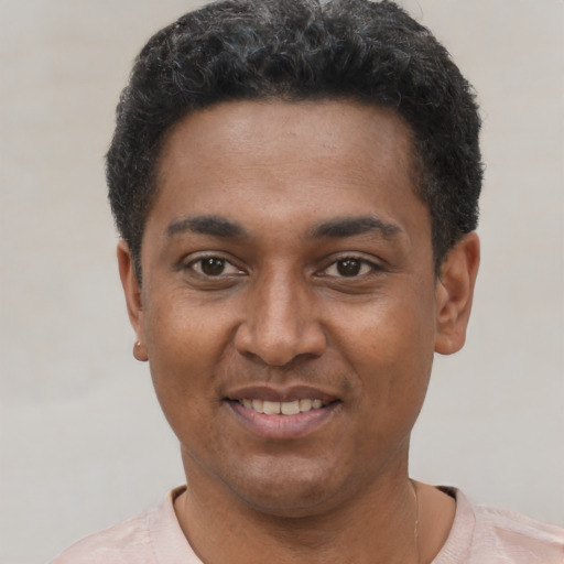 Joyful latino young-adult male with short  black hair and brown eyes
